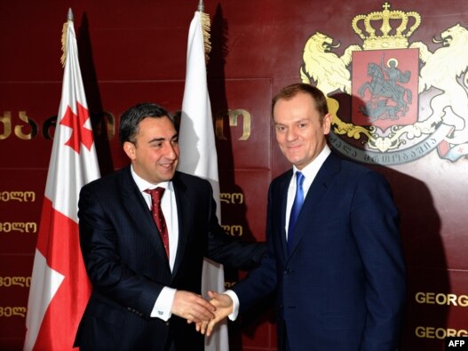 Georgian Prime Minister Nika Gilauri (left) welcomes Polish Prime Minister Donald Tusk to Tbilisi.
