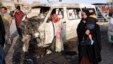 A woman walks near the site of a car-bomb attack in Baghdad's Sadr City on May 16. 