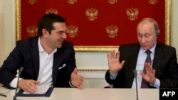 Greek Prime Minister Alexis Tsipras (left) speaks with Russian President Vladimir Putin during a signing ceremony at the Kremlin in Moscow in April.