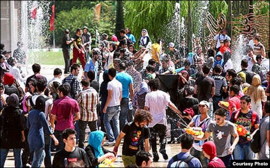 Young Iranians gathered to spray water on each other last week in Tehran.