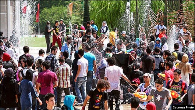 Young Iranians gathered to spray water on each other last week in Tehran.