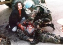A civilian and a NATO soldier give aid to a Bosnian injured in Sarajevo's 
