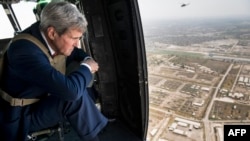 U.S. Secretary of State John Kerry looks out over Baghdad from a helicopter during a visit to the Iraqi capital on September 10.
