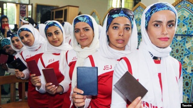 Women wait in line to cast their votes in parliamentary elections in Tehran on February 26.