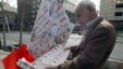 A man reads a campaign pamphlet in central Tehran ahead of Iran