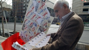 A man reads a campaign pamphlet in central Tehran ahead of Iran's 2012 parliamentary elections.