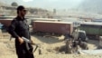 A Pakistani security officer stands guard over long lines of NATO trucks and oil tankers at a border crossing amid a blockade against NATO vehicles transporting supplies to Afghanistan via Pakistan. The blockade has been in place since November 26, when 2