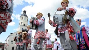 Wearing traditional attire, Belarusian musicians march during city-holiday celebrations on May 26 in Nesvizh, some 120 kilometers south of Minsk. (AFP/Viktor Drachev)