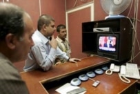 Iraqis in Baghdad watching the news on television (epa file photo)