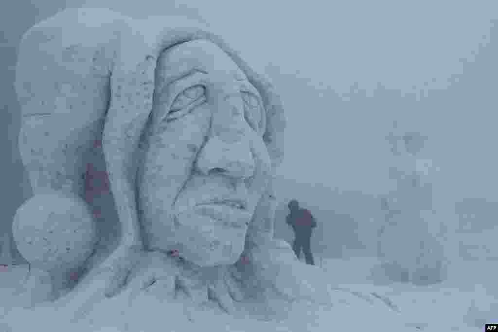 A snow sculpture is pictured during the 15th International Sculpture Symposium "Snow Kingdom 2013" in Pustevny, Czech Republic. The event attracts more than 30 artists and is attended by around 10,000 visitors. (AFP/Radek Mica)