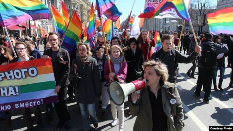Natalya Tsymbalova (right foreground) leads a march by the Alliance of Heterosexuals for LGBT Equality in St. Petersburg.