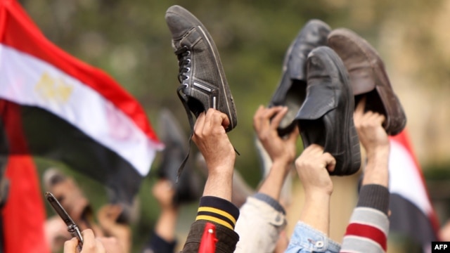 Antigovernment protesters wave their shoes outside the state television building in Cairo in February 2011 during protests that led to the ouster of President Hosni Mubarak.