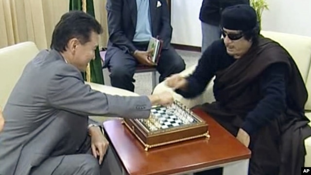 Staving off what many expected would be a quick checkmate has become something close to victory for Libya's Muammar Qaddafi (right).