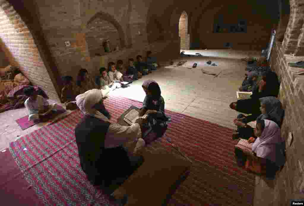 Afghan children read the Koran in a madrasah, or religious school, in Herat Province during the Muslim holy fasting month of Ramadan. (Reuters/Mohammad Shoib)