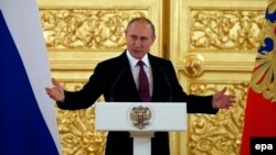 Russian President Vladimir Putin speaks during a personal send-off for members of the Russian Olympic team at the Kremlin in Moscow on July 27.