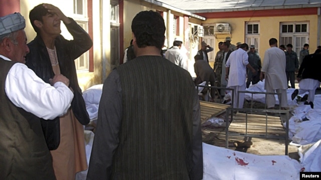 Relatives of victims cry at a local hospital after the bomb blast in Faryab Province.