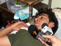 Xalil speaks with reporters from his hospital bed after the stabbing (RFE/RL)