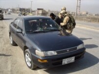 British troops conducting a vehicle check on a Kabul road, February 2006 (RFE/RL)