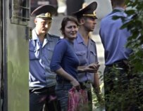 One of the four, Enira Branitskaya, with police on August 1 (Bymedia.net)