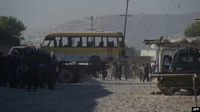 The minibus being taken away following the suicide attack in Kabul.