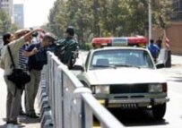 Police and journalists at the scene after the British Embassy was fired upon on 3 September 2003