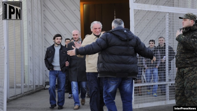 Inmates recently classified as political prisoners leave a Georgian prison on January 13.