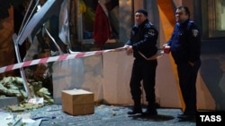 Police officers examine the site of an explosion at a building where an office collecting assistance for the Ukrainian military is based in Odesa last month. This incident was just one of many bombings across Ukraine in recent weeks.