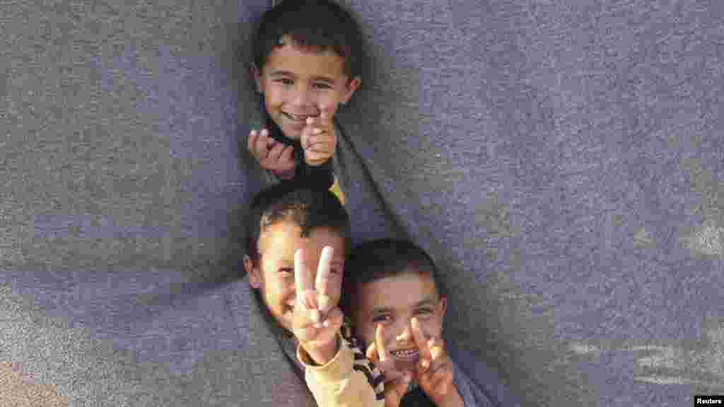 Young refugees who fled the violence in Syria are seen at the Bashabsha camp near the Jordanian city of Al Ramtha, at the Syrian border on July 25. (REUTERS/Majed Jaber)