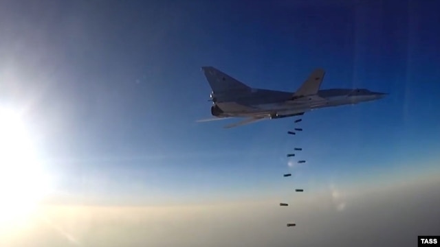 A still image taken from video footage and released by Russia's Defense Ministry on August 14 shows a Tu-22M3 dropping bombs near what the ministry said is the city of Deir ez-Zor, Syria.