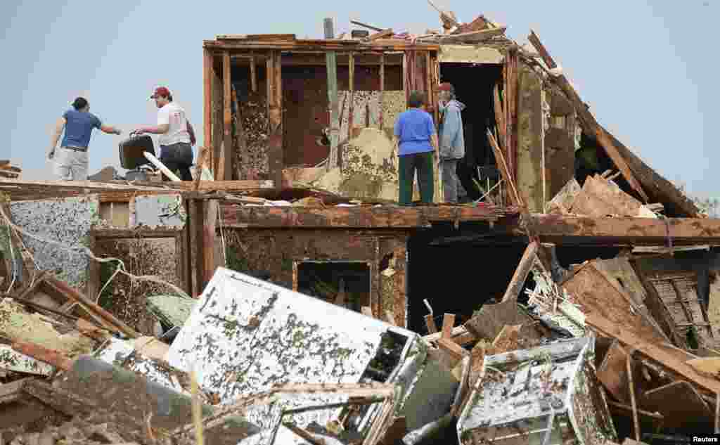People search for their belongings in the wreckage of their homes.