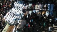 Syria -- Opposition activists shows mourners gathering around coffins and bodies during a mass funeral in the flashpoint city of Homs, 04Feb2012 