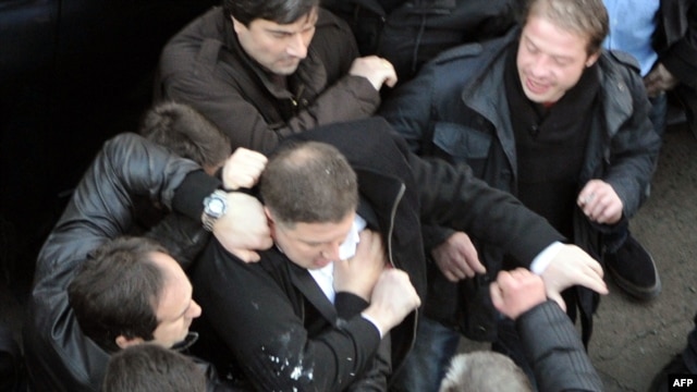 Tbilisi Mayor Gigi Ugulava (center) scuffles with protesters in Tbilisi.