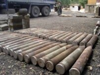 UN officials in Laghaman, Afghanistan, examine weapons that were turned in to a weapons-destruction program earlier this month (epa)