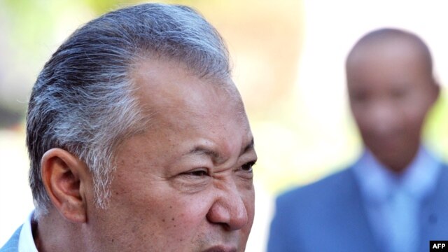 Kyrgyz President Kurmanbek Bakiev speaks to reporters after voting in Bishkek on July 23.
