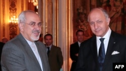 French Foreign Minister Laurent Fabius (right) welcomes his Iranian counterpart, Mohammad Javad Zarif, to the Foreign Ministry.