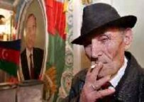 A man smokes a cigarette after voting in Baku on 6 November (epa)