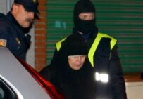 Police escort a veiled woman from the scene of a 10 January operation aimed at breaking up alleged terrorist cells based in Spain. (epa)