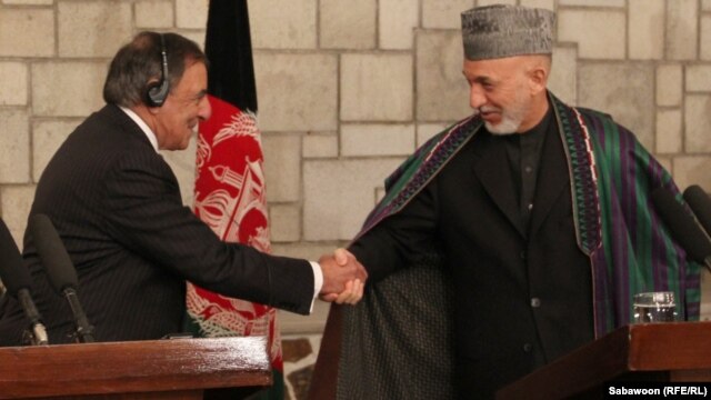 U.S. Defense Secretary Leon Panetta (left) shakes hands with Afghanistan President Hamid Karzai in Kabul on December 13.