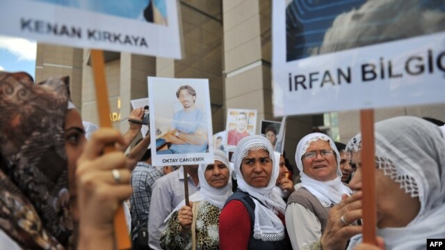Kurdish women hold placards showing jailed journalists at the start of the trial in Istanbul in September of 44 reporters with suspected links to rebels from the Kurdistan Workers Party.