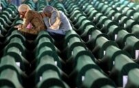 Bosnian Muslim women mourn at a mass burial of victims of the Srebrenica massacre, July 2005 (AFP)