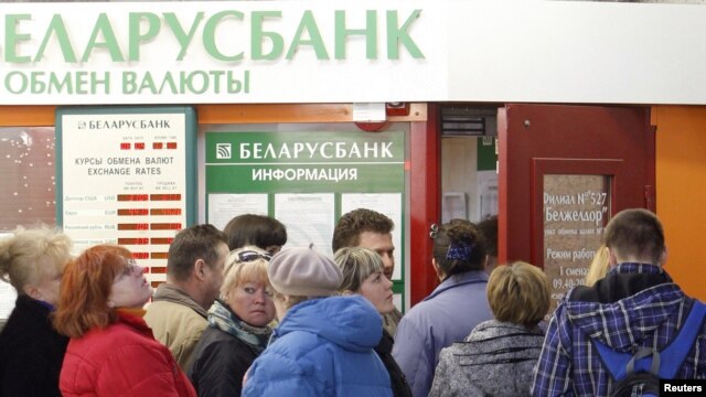 People line up to buy foreign currency outside a bank's exchange office in Minsk on April 6.