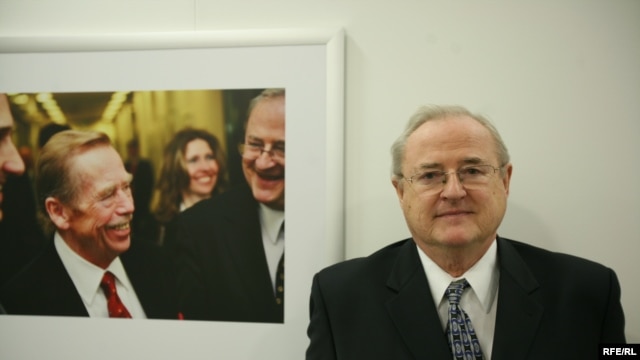 Pavel Pechacek poses next to a picture of former Czech President Vaclav Havel at RFE/RL headquarters