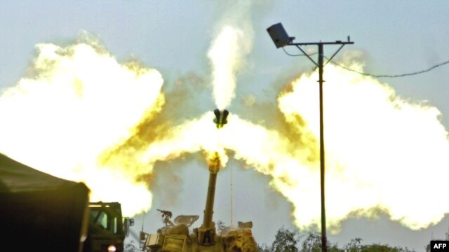 Israeli artillery fires toward the Gaza Strip from the Israeli side of the Israel-Gaza border on January 4.
