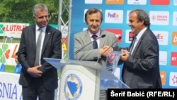 Michel Platini (right) attends the opening of a soccer training center in Bosnia