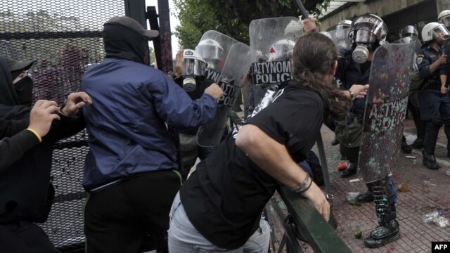 Greek protesters clashed with riot police protecting the Greek Parliament in Athens on October 9.