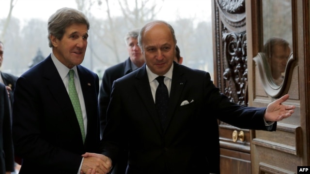 U.S. Secretary of State John Kerry (left) is welcomed by French Foreign Affairs Minister Laurent Fabius at the Quai d'Orsay Ministry in Paris on February 27.