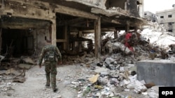 A man walks past destroyed buildings in the Yarmouk Palestinian refugee camp in the Syrian capital, Damascus, that has been overrun by Islamic State militants in recent days.
