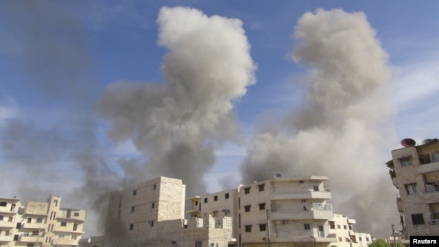 Smoke rises after a Syrian government fighter jet fired missiles at Marat al-Numan, near the northern province of Idlib, on October 30.
