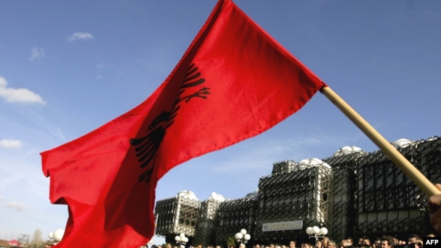 A Kosovar Albanian waves the Albanian flag during a protest against deployment of the EU mission in Pristina ealier this month.