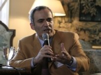 Kasparov speaking on the sidelines of the conference on June 5 (RFE/RL)